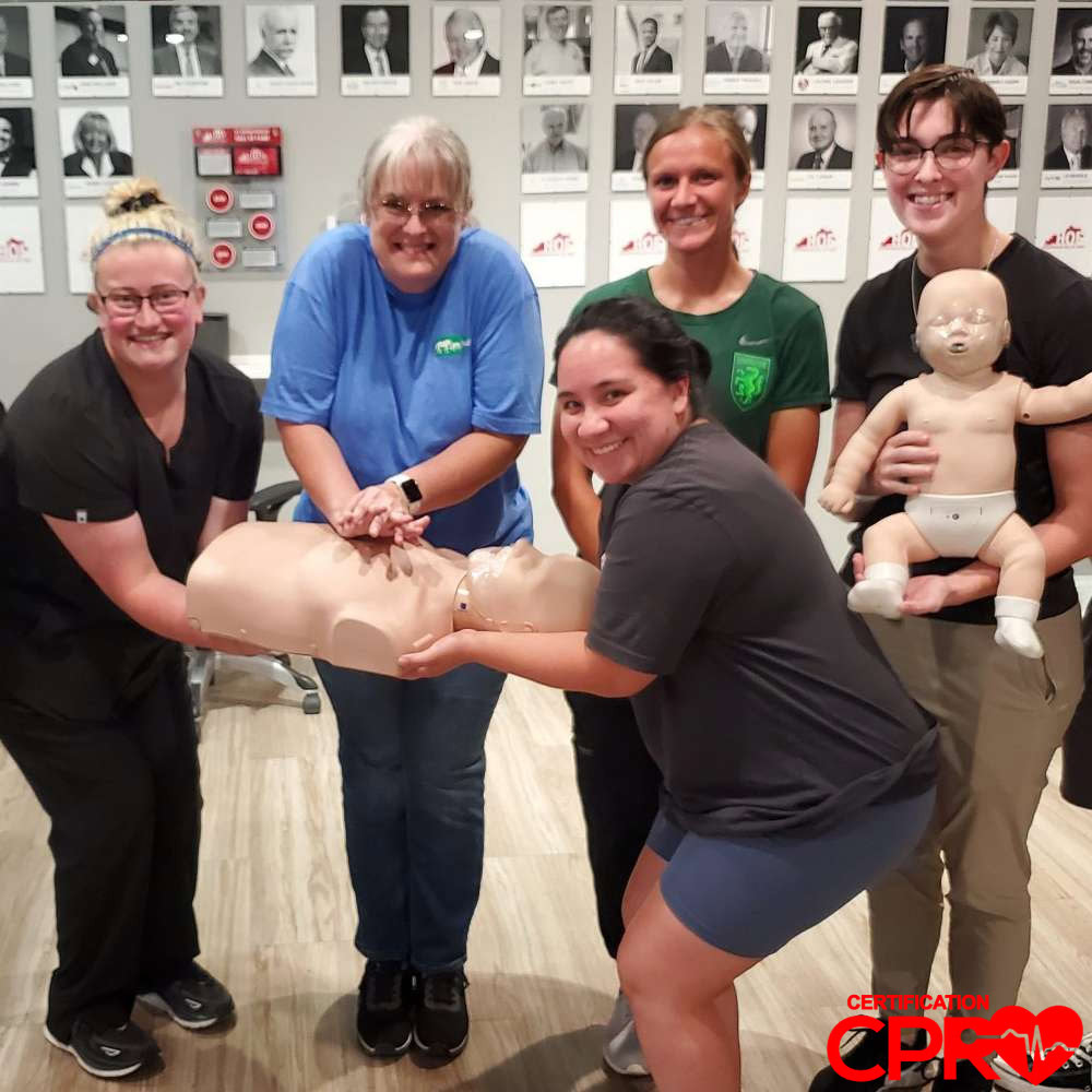 CPR training class in Atlanta with students practicing on mannequins.