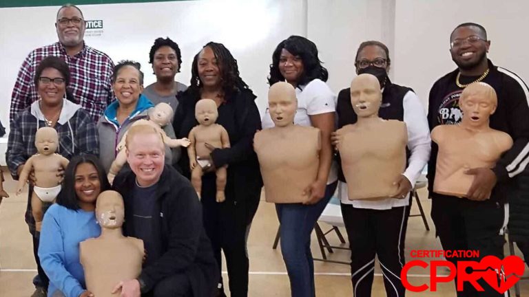 Group CPR training session in Atlanta with mannequins for certification.